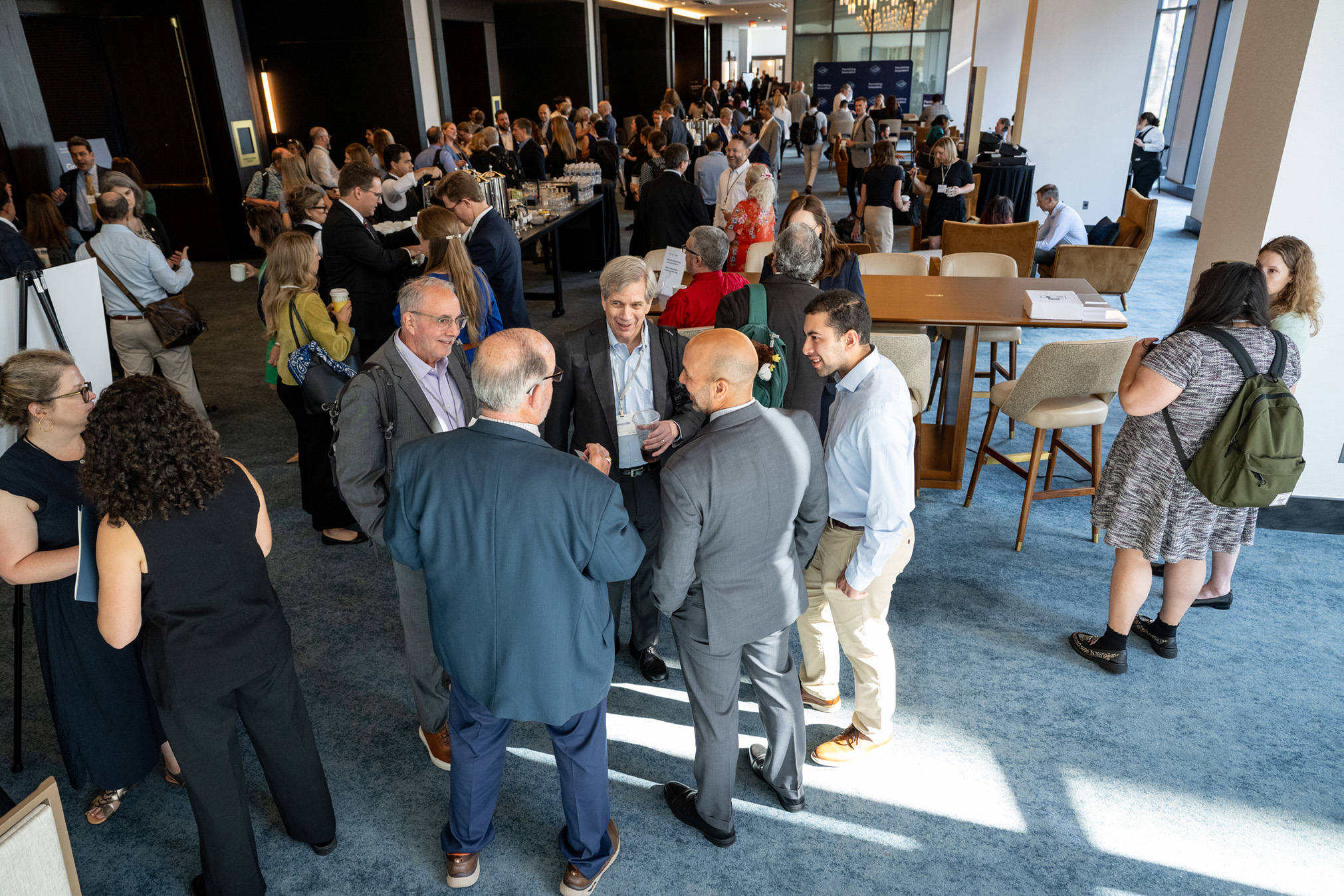 Attendees mingle in small groups.
