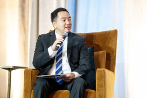 David Yi poses a question on stage.