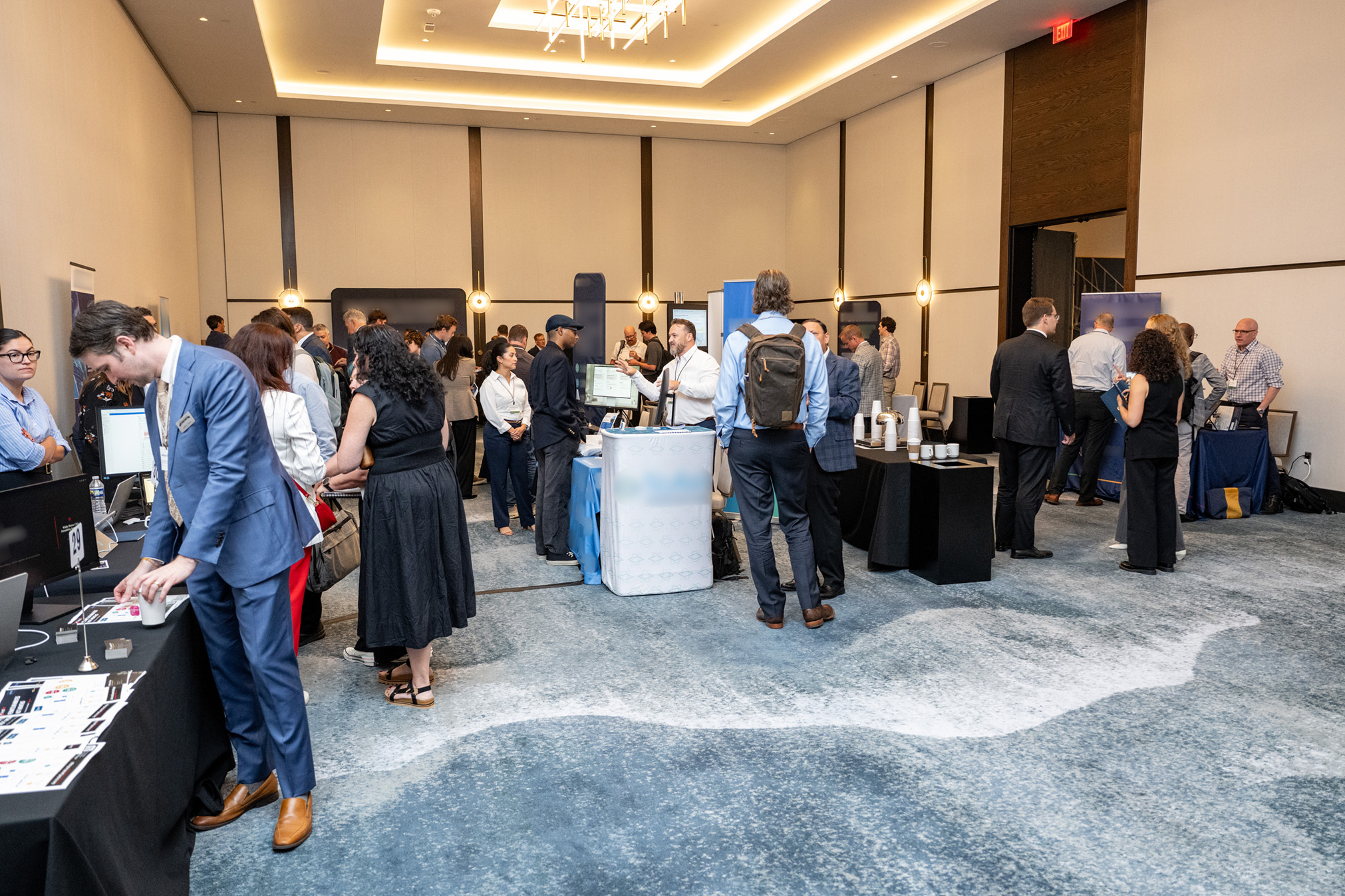 Attendees talk in groups on the demo floor.